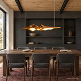 Luma Haven Wood Pendant Light, Wood Color, above a long dining table in daylight