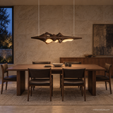 Luma Haven Wood Pendant Light, Walnut Color, above a long dining table in evening light
