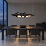 Luma Haven Wood Pendant Light, Black, above a dining table in a cool-toned evening room