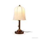 Rora Morrow Wood Table Lamp, walnut and white floral shade, lit on white background