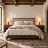 Two matching Rora Morrow Wood Table Lamps lit beside a centered bed
