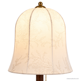 Close detail of the lit Rora Morrow floral fabric shade and gold finial