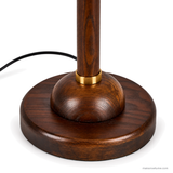Close detail of the Rora Morrow walnut base, gold collar and power cord