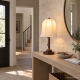 Rora Morrow Wood Table Lamp lit on an entry console in daylight