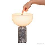 Close-up of a finger touching the top control of the Vian Linden Marble Table Lamp in Grey.