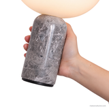 Close-up of the veined Grey marble base and rounded shoulder of the Vian Linden Marble Table Lamp.